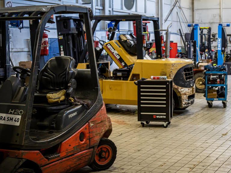 Photo d'un atelier dans lequel se trouvent deux chariots élévateurs en cours de réparation